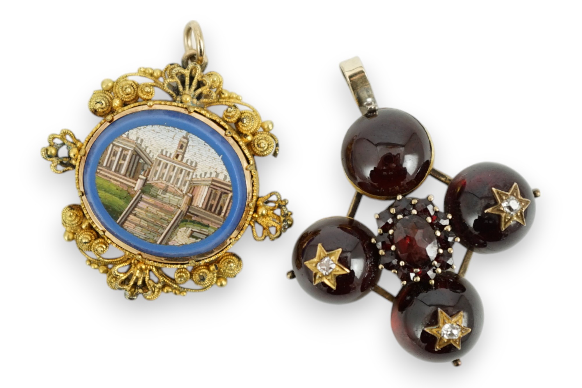 A 19th century gilt metal mounted micro mosaic pendant, 32mm, together with a similar cabochon garnet and diamond set quatrefoil pendant.